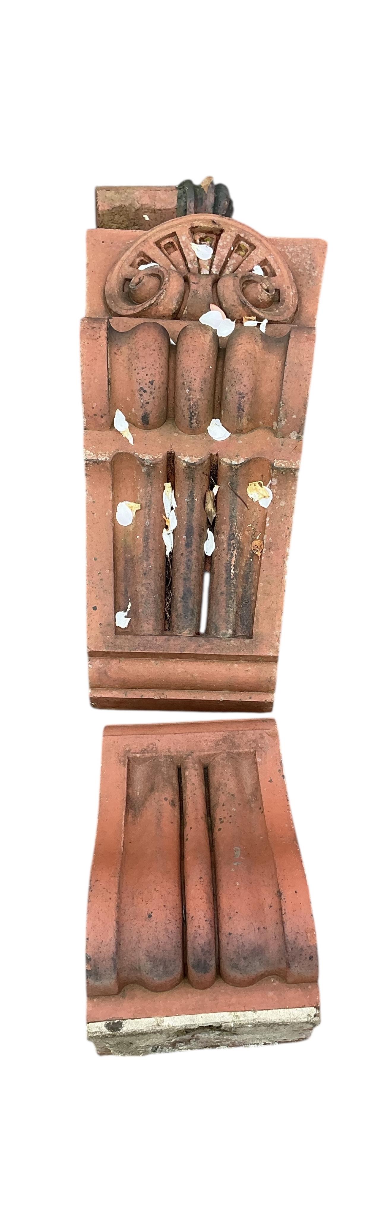 A Victorian terracotta country house armorial plaque, height 150cm with serpentine scroll corbels